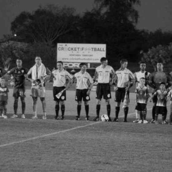 Adelaide United FC and the NorZone All Stars link arms and say No More to family violence