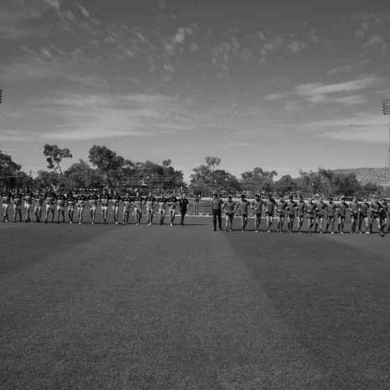 Melbourne and Port Adelaide link arms. Photo Credit: AFL Media