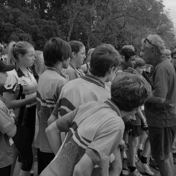 15 years and under runners listen closely to Charlie talk about the linking of arms.
