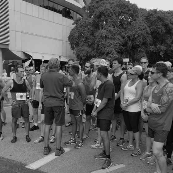 Charlie speaks to the Masters runners about the linking of arms.