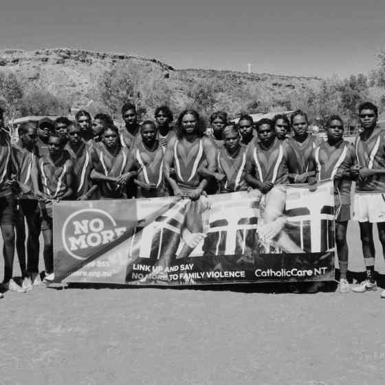 Hermannsburg linking arms before the start of the match.