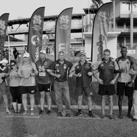 Saints club members link arms in a symbolic statement to say NO MORE family violence. 
