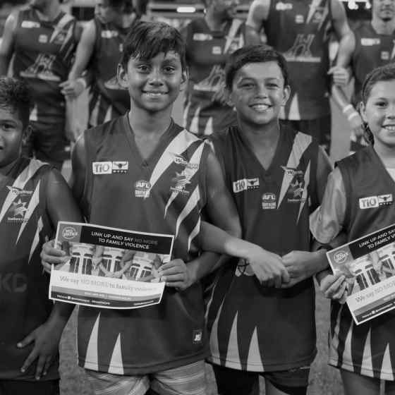 Wanderers FC juniors link arms before the match. 