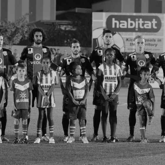Adelaide United FC stand united with junior players from Darwin Olympic SC before the FFA Cup Round of 32 match in Darwin.