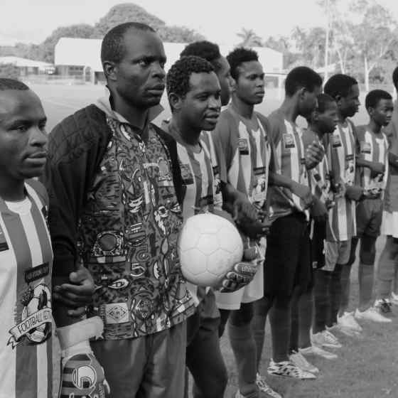 Congolese team linking arms before the match.