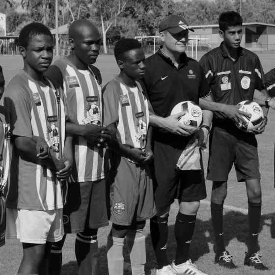 Congolese team and referees linking arms before the match.
