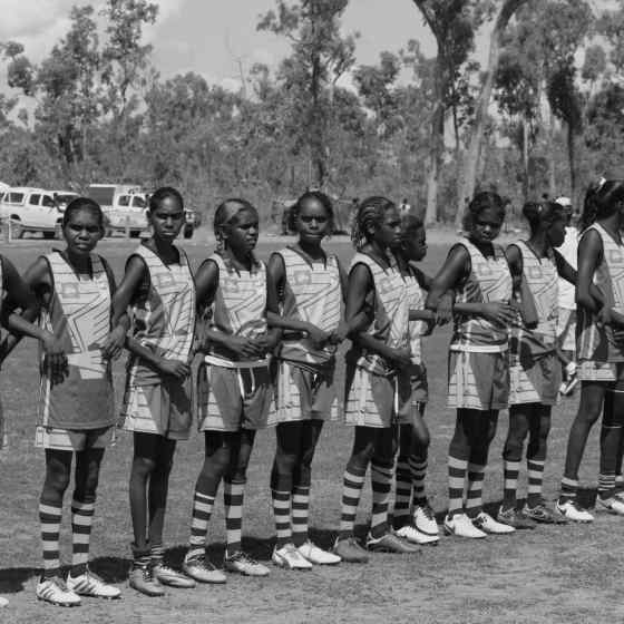 Hawks link arms to prior to the women's grand final match. 
