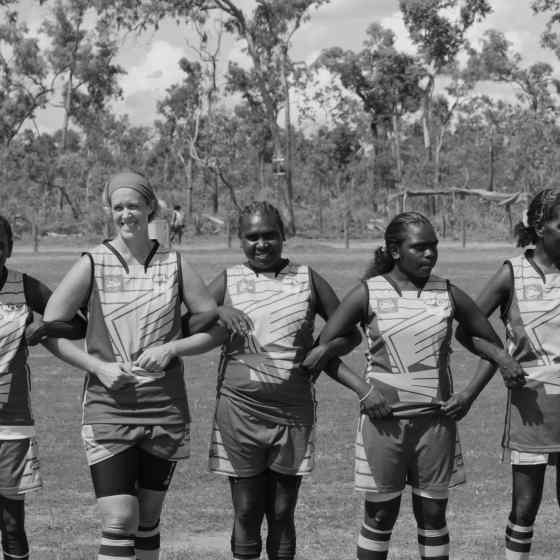 Hawks link arms before the women's grand final match.