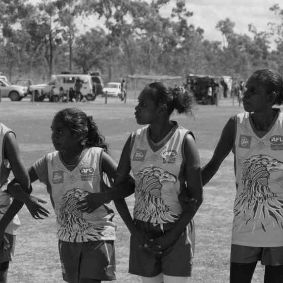 Damala Eagles link arms before the women's grand final match.