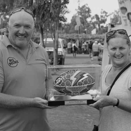 Malcom Fox presents the NT Thunder NO MORE Campaign ball to the raffle winner, Toni.