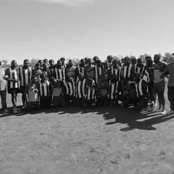 Mulga Bore links arms with Laramba Cowboys after winning the Div. 2 competition. 