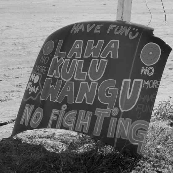 Local artists painted an old car bonnet with their local Walpiri language saying NO MORE violence.