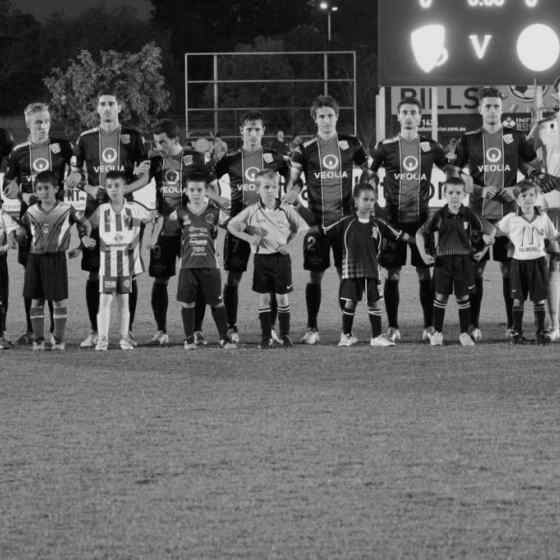 Adelaide United FC link arms in front of 1,200 supporters